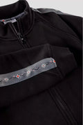 Damen Jacke mit Edelweiss-Muster, Stehkragen und Taschen.